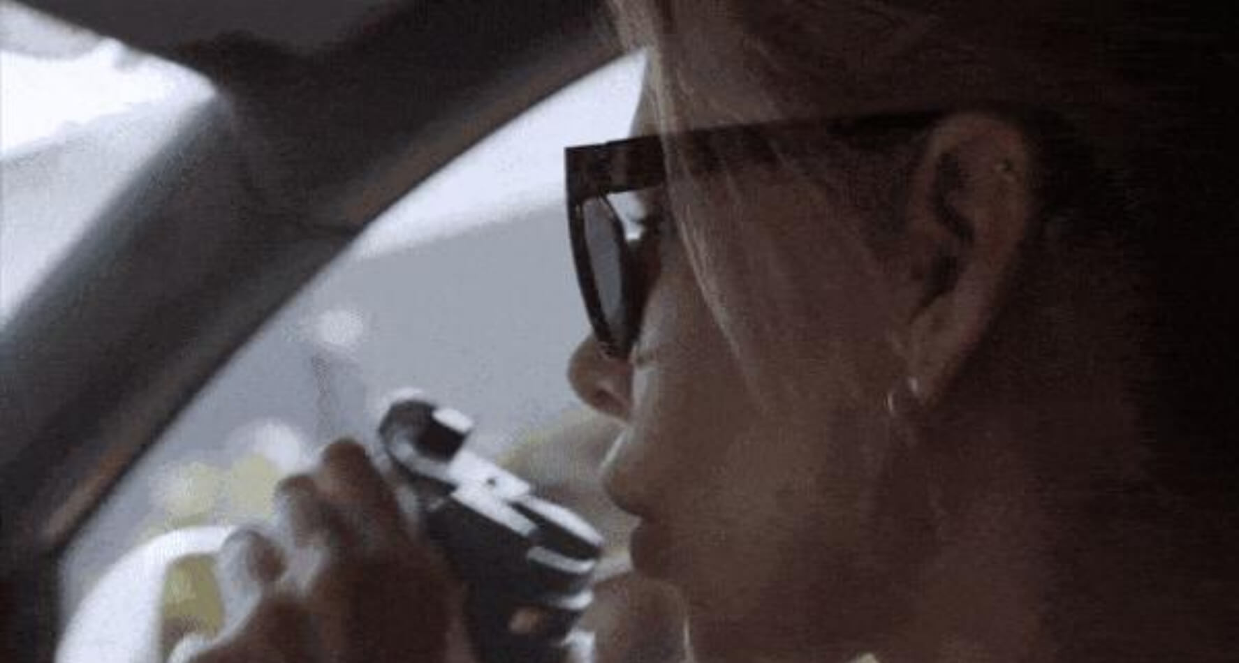 Thermy Bottle in the car with a woman sipping from it